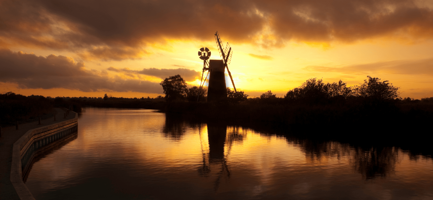 Turf Fen Mill on the Norfolk Broads at sunset. Planning a family kayaking holiday.