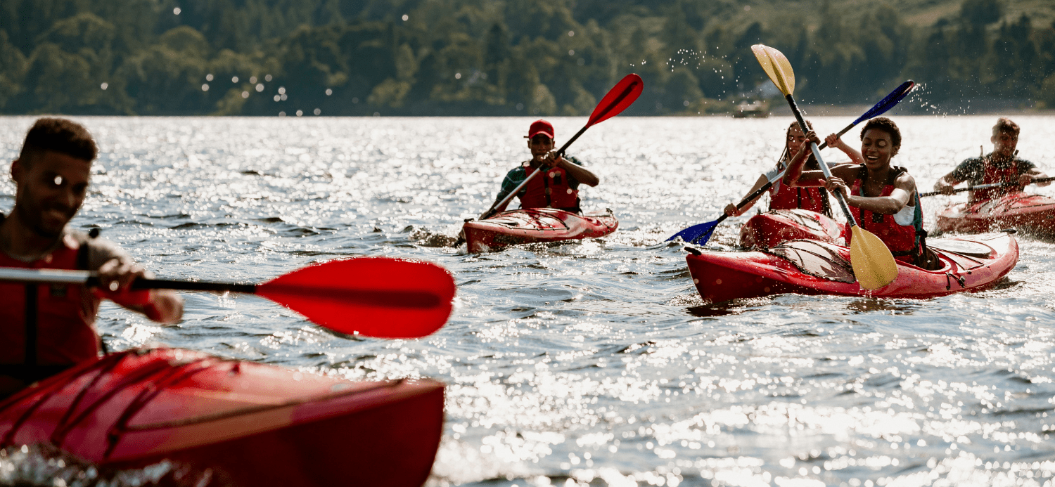 Group of friends kayaking at the Lake District. Planning a family kayaking holiday.