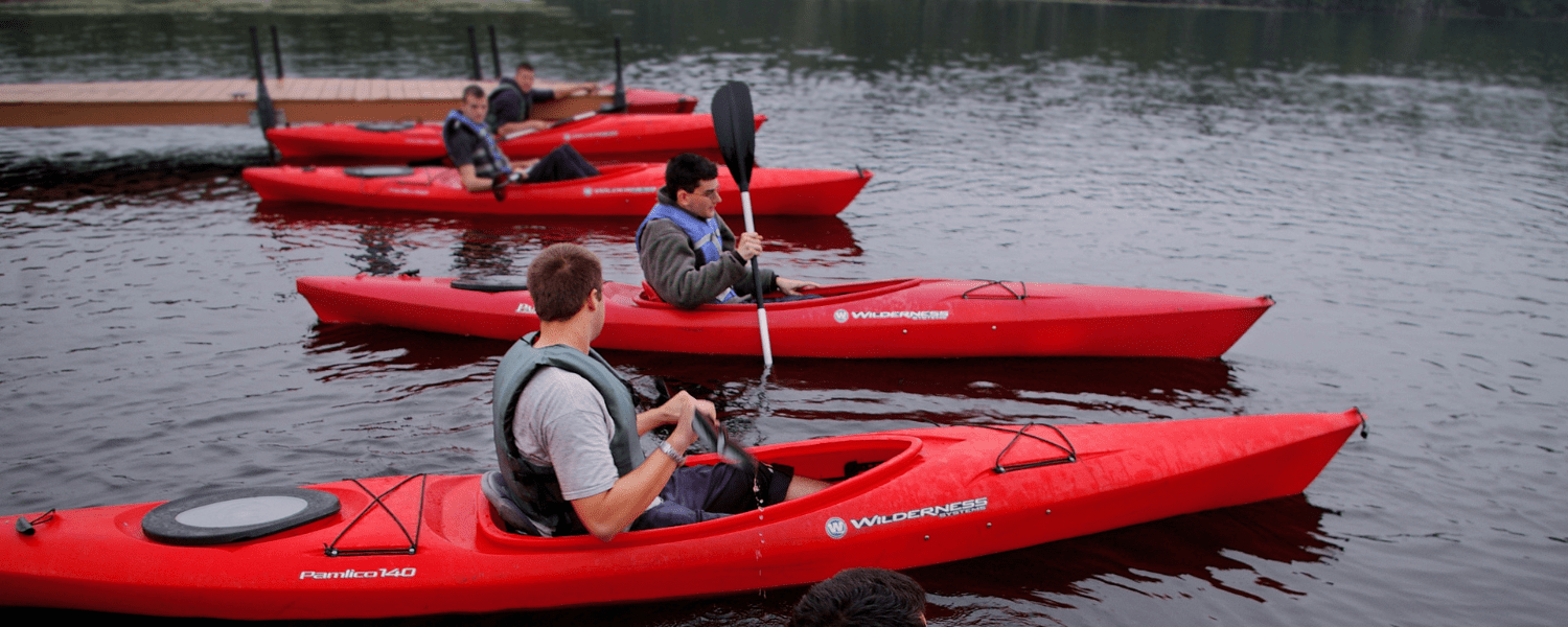 kayakers lined up discussing safety tips