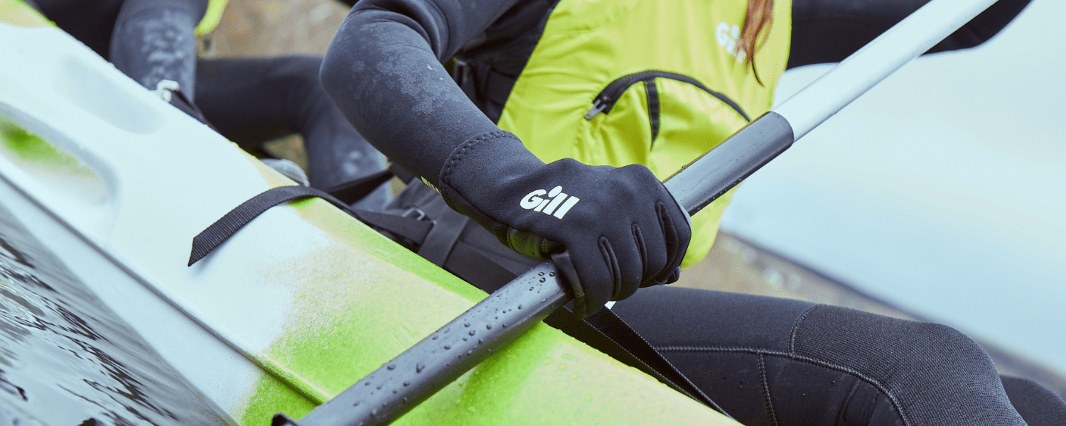 a kayakers hand wearing a 3 season glove