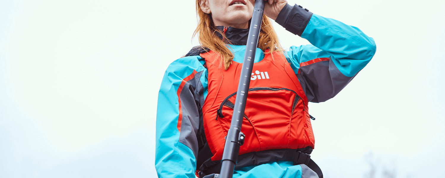 female wearing a Gill pro top while paddling