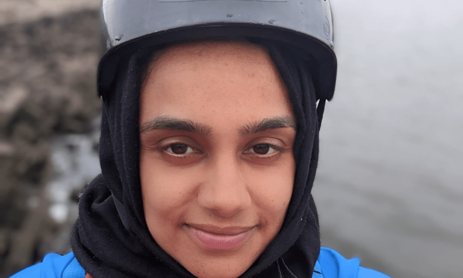 young muslim girl with hijab on underneath helmet