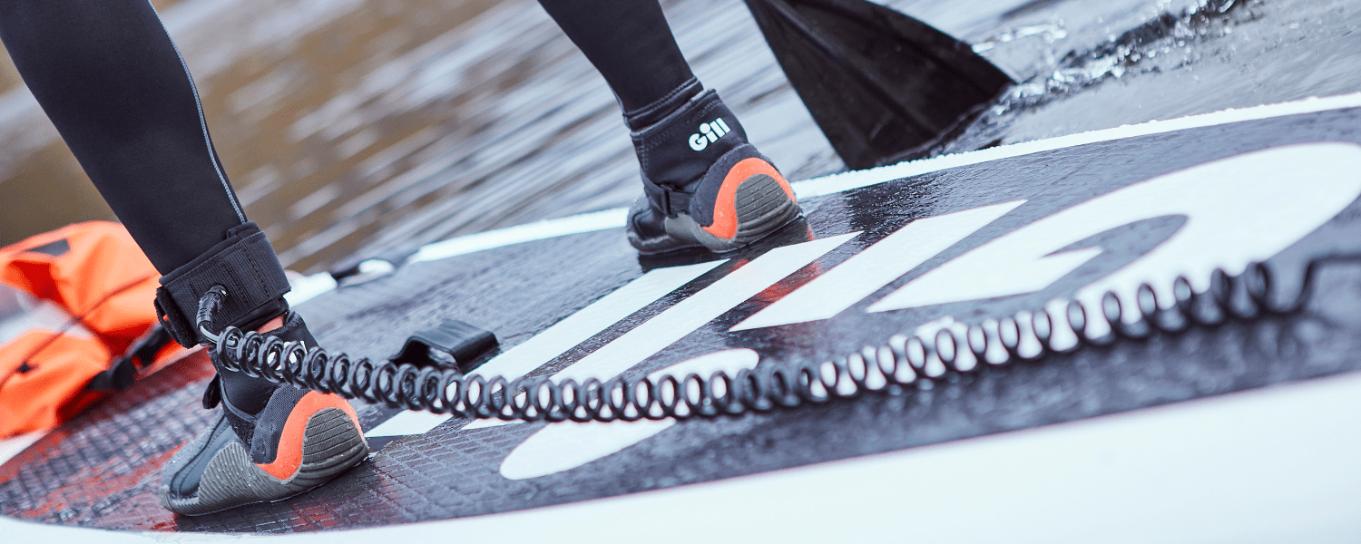 feet on a paddle board enjoying the water