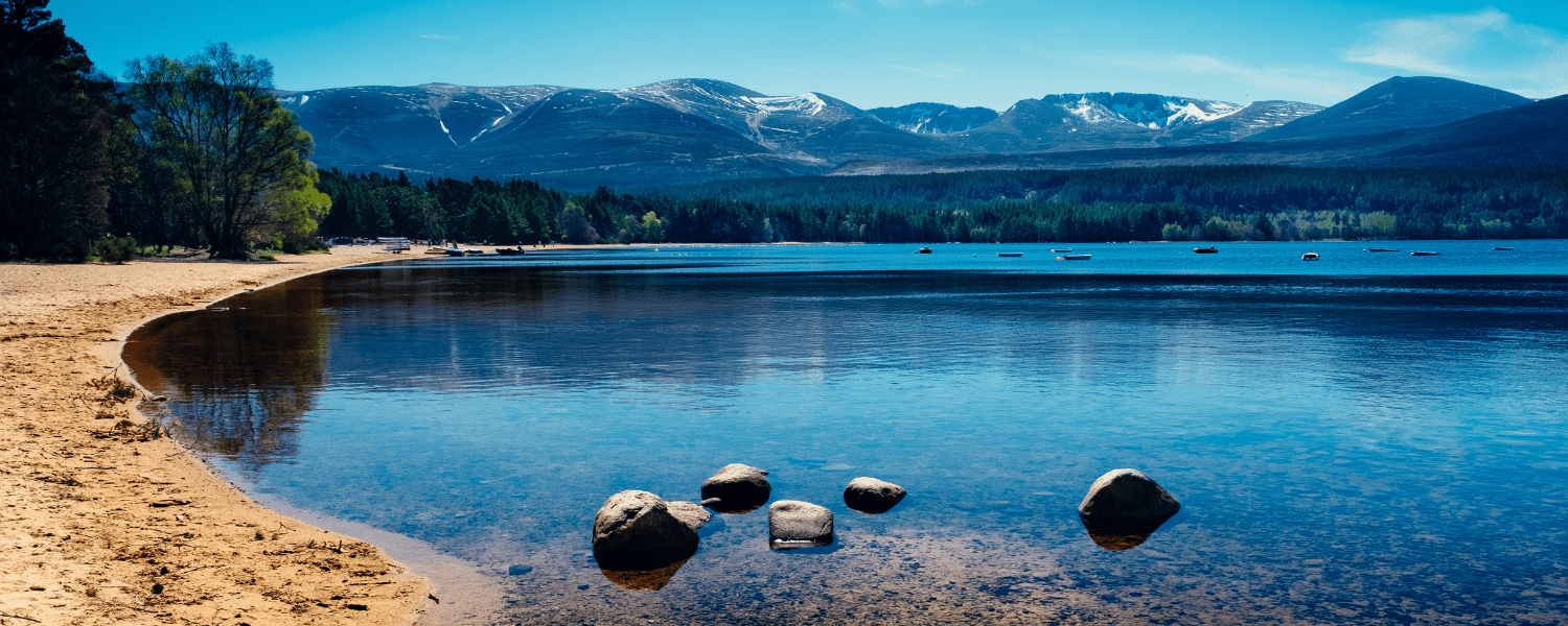 a still lake at the foot of the Cairngorm mountains