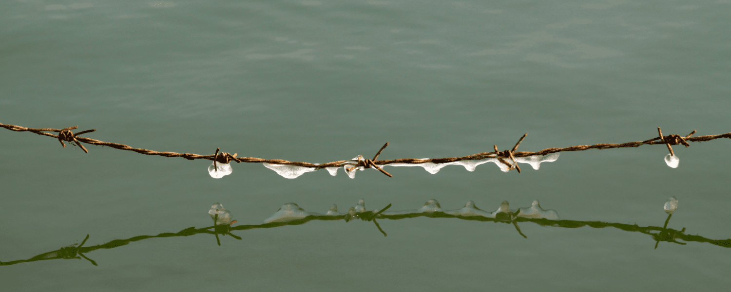 A line of barb wire across a body of water