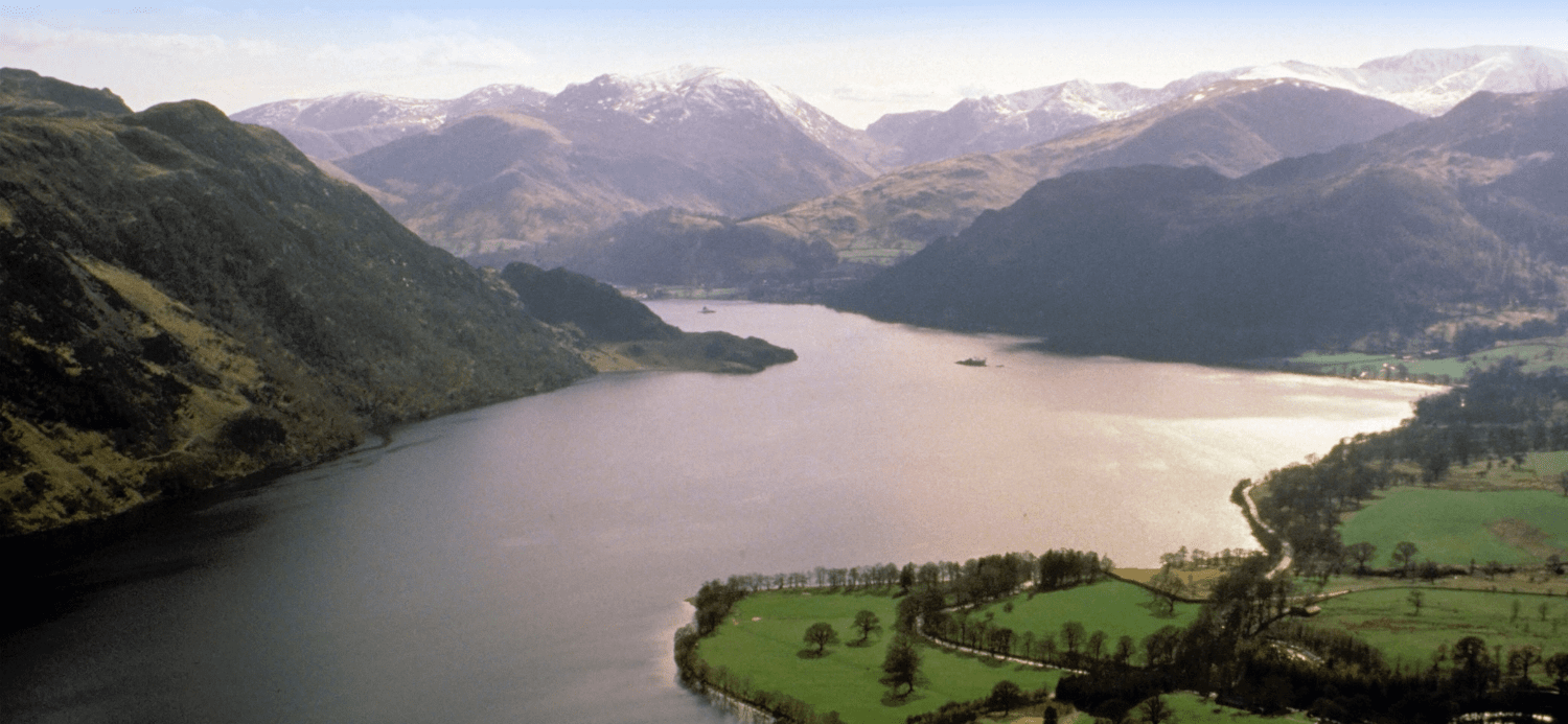 a lake with some tall mountains in the background