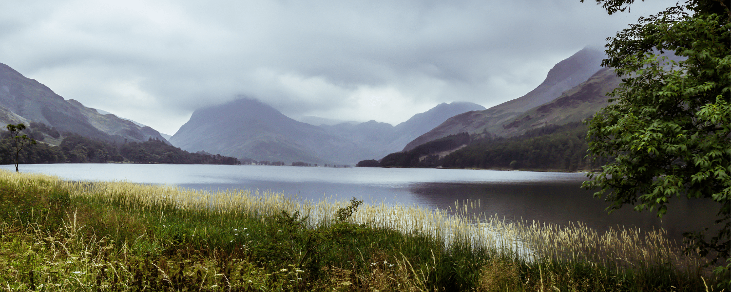 one of the lake district lakes accompanied by one of the many mountains