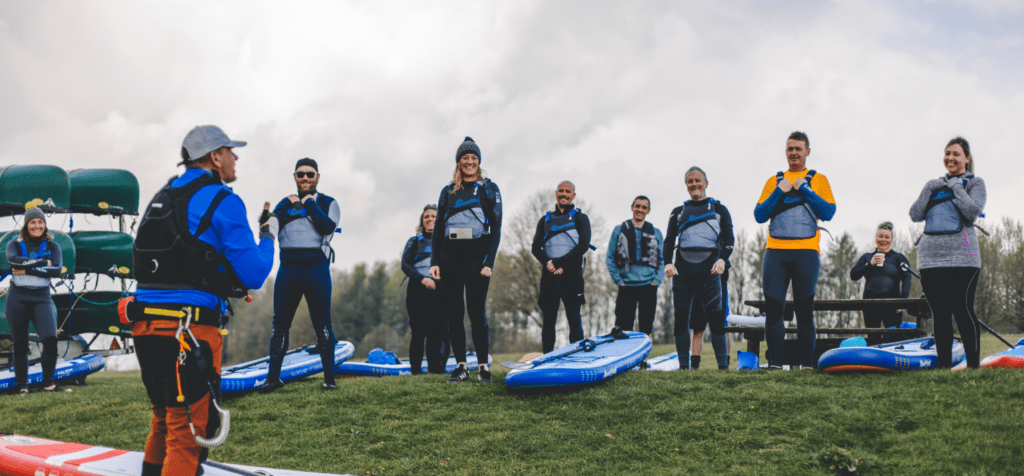 group of people listening to an instructor in full safety kit