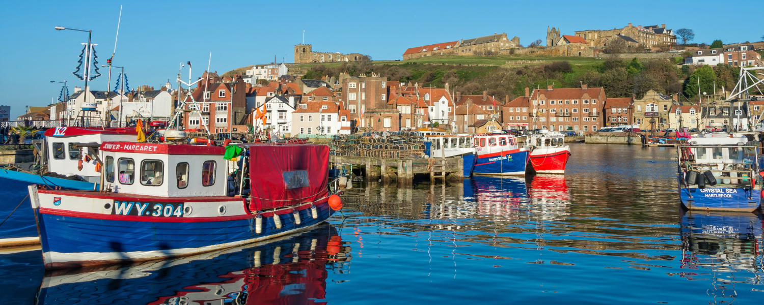 whitby harbour filled with colourful fishing boats