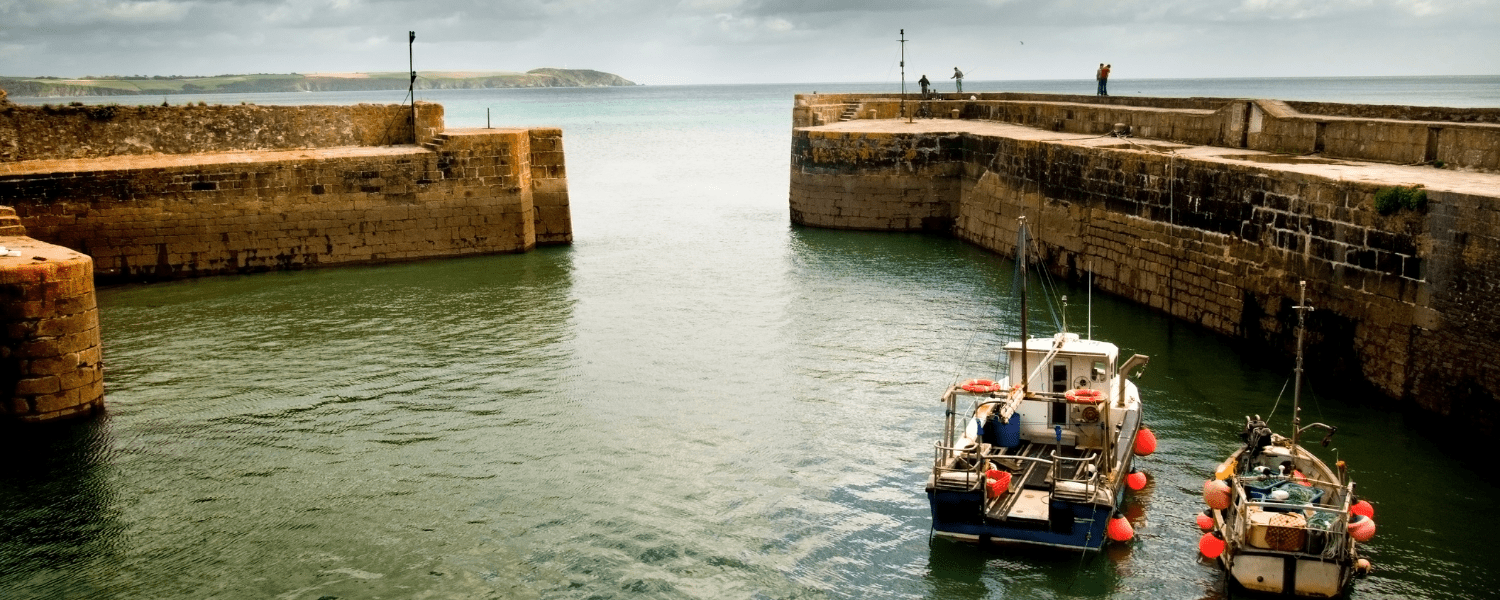 a small barbour enclosed by walls looking out to open sea