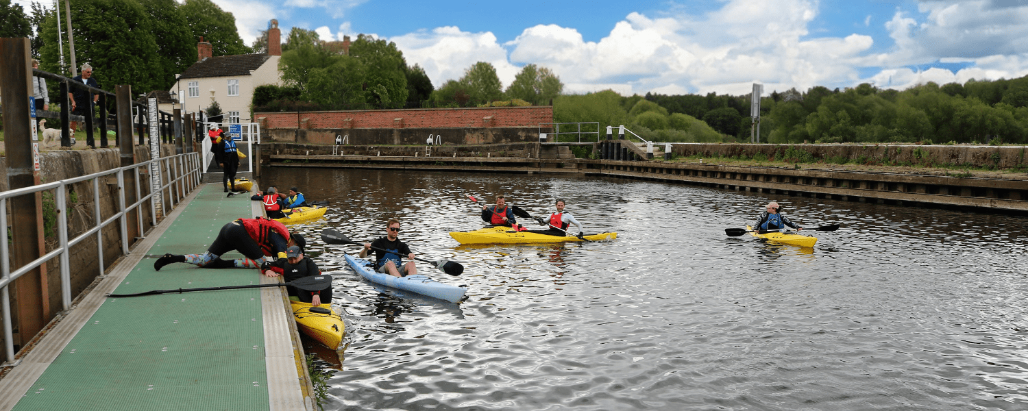 group of kayakers launching ready to paddle together