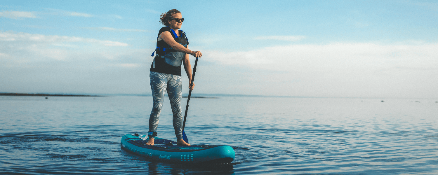 a woman on a sup on the sea