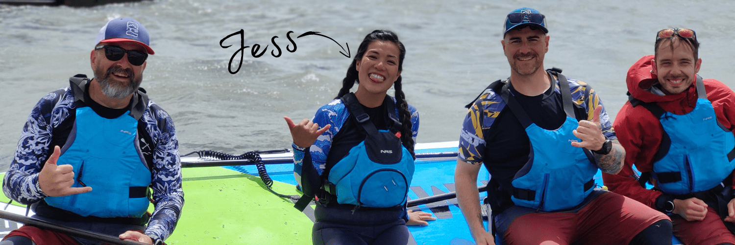 three men and one woman sat on a paddleboard 