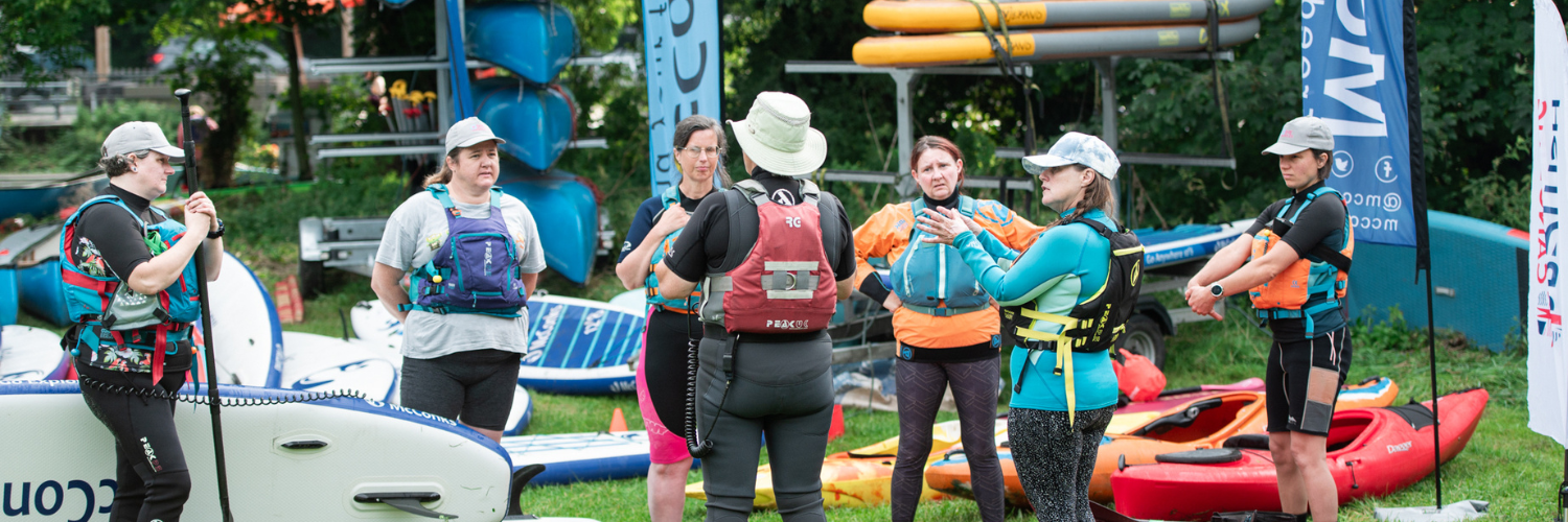 group of women discussing paddleboarding