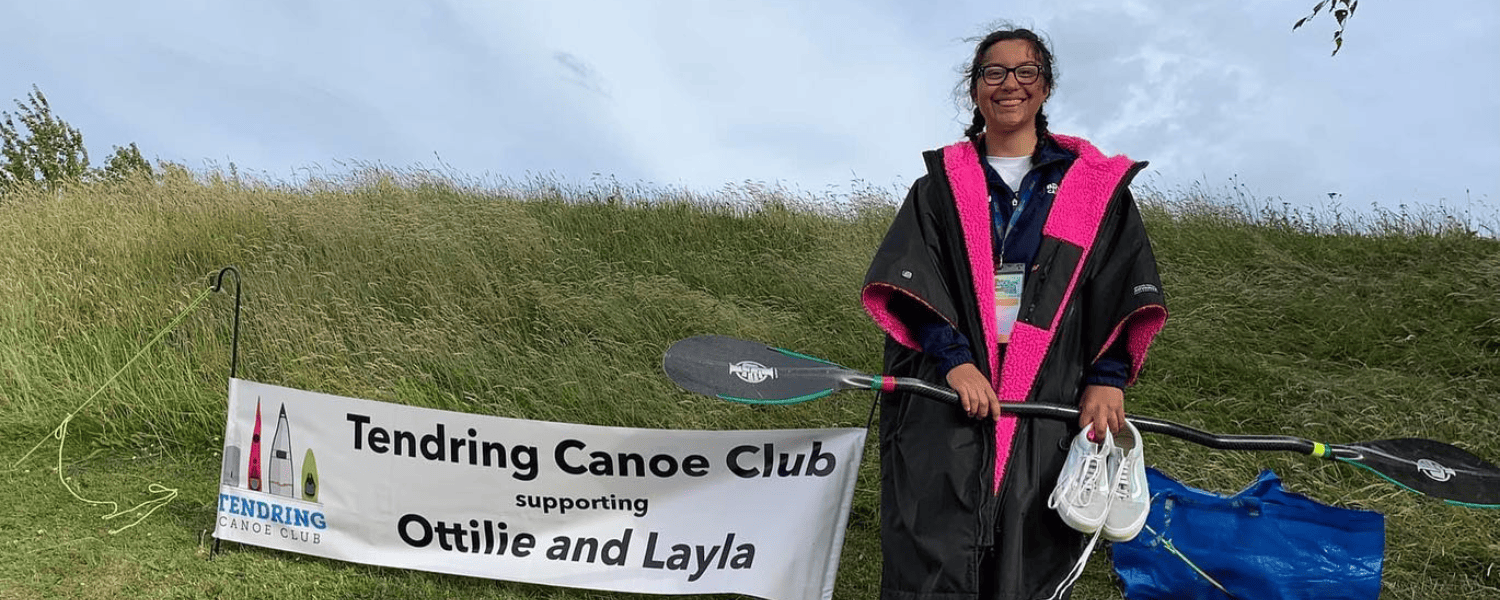 Layla stood next to her home club banner