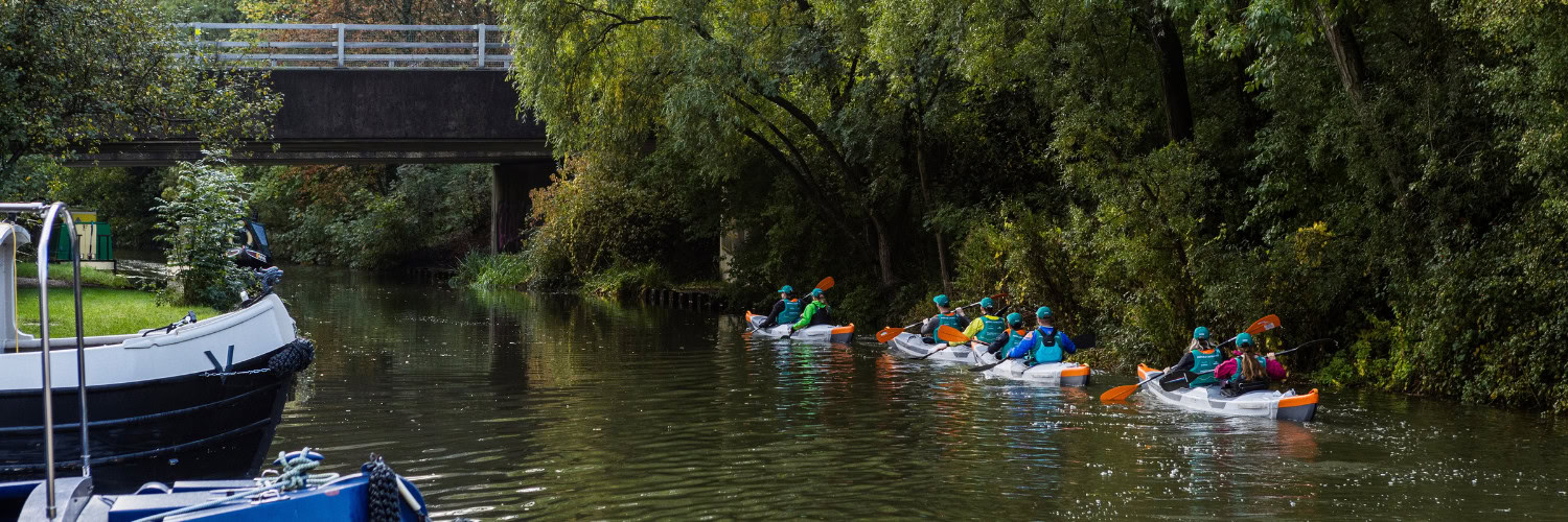 paddling under a bridge