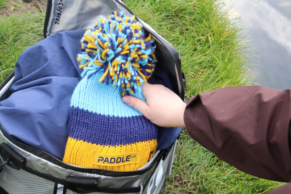Planning a safe autumn and winter paddle. Packing a harm hat and spare clothing in a dry bag.